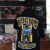 Person wearing a 'Death Row Records' jacket in a record store.